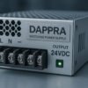 Industrial SMPS power supply module with DAPPRA-branded label plate on engineering workbench.